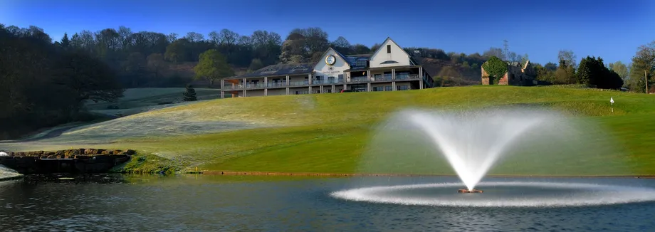A long shot image of Welsh Celtic Manor featuring a lake with a fountain.